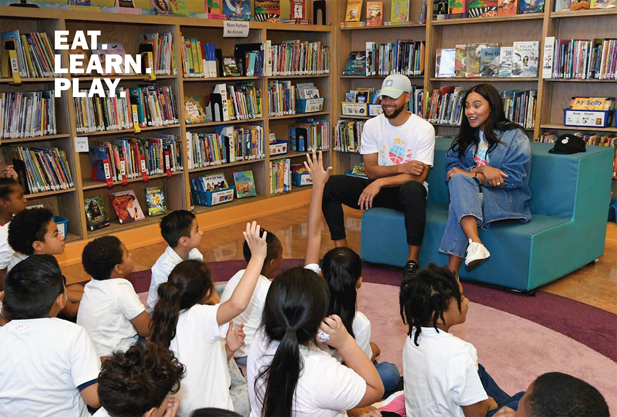 Photo of Steph and Aiysha Curry taking questions from students in a library