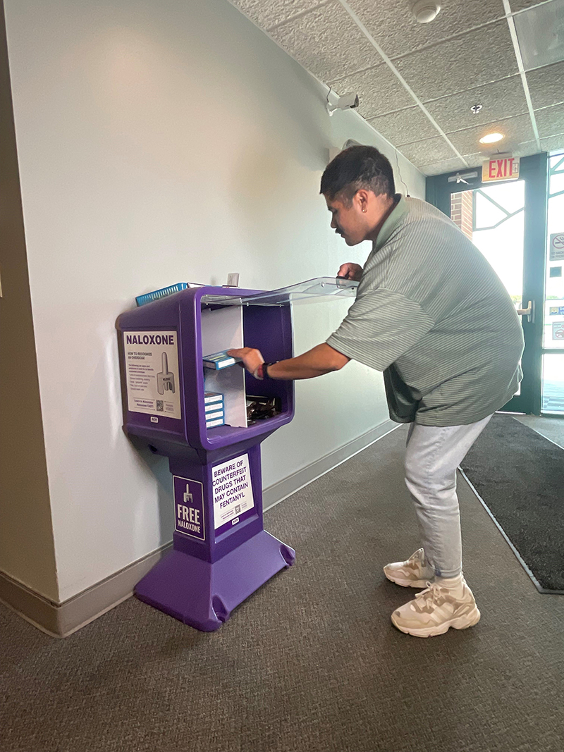 Hector Contreras uses one of First Call's no-cost naloxone distribution kiosks