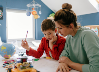 Mom helping son with homework