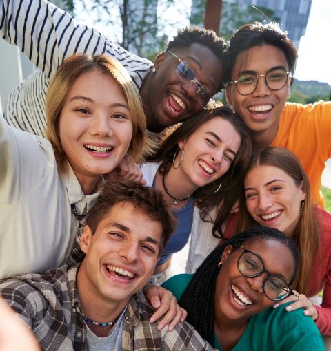 group of diverse youth posing for a selfie