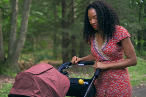 Woman pushing baby in stroller